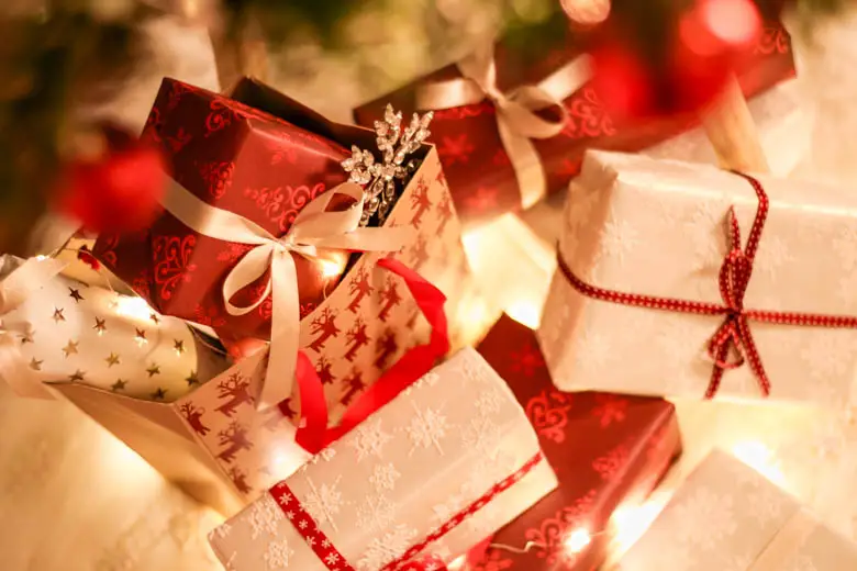 Bunch of presents wraped in white and red paper - how to get into the Christmas spirit