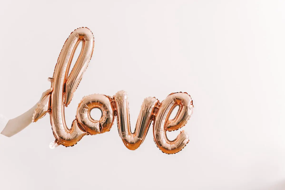 Balloon sign saying love on the white background - featured image for how to spend Valentine's Day with your kids