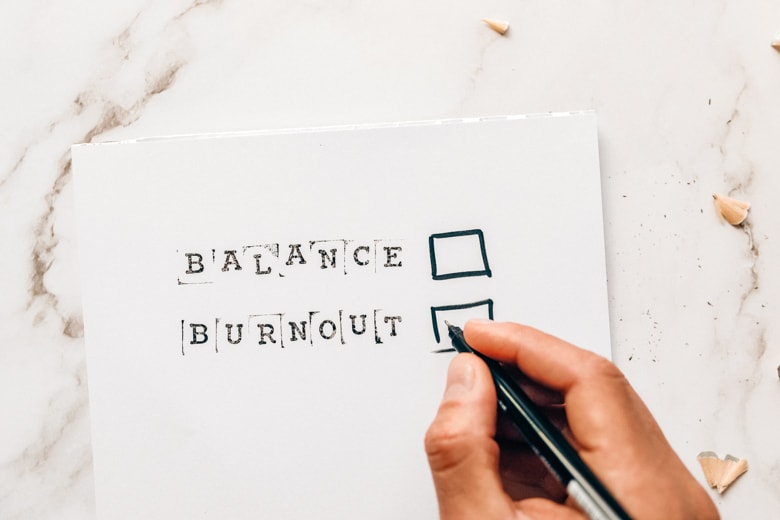 Card saying balance or burnout and person choose the second option - featured image for blogger burnout